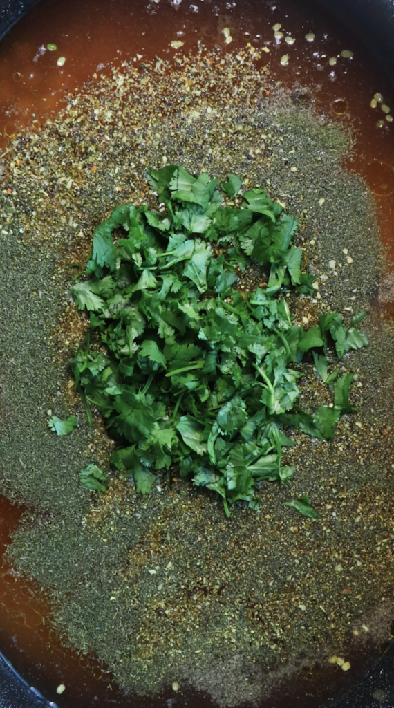 1. Add rinsed rice and mung beans to a large Dutch oven, then add water, beef broth, tomato sauce, oil, chickpeas, seasonings, and cilantro. 